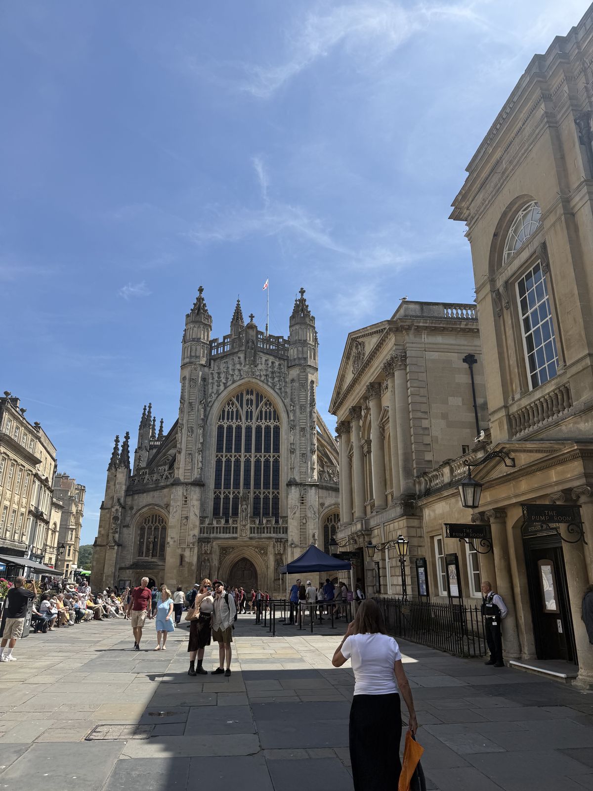 The west front of Bath Abbey seen from its courtyard, carved stone rising above the paving