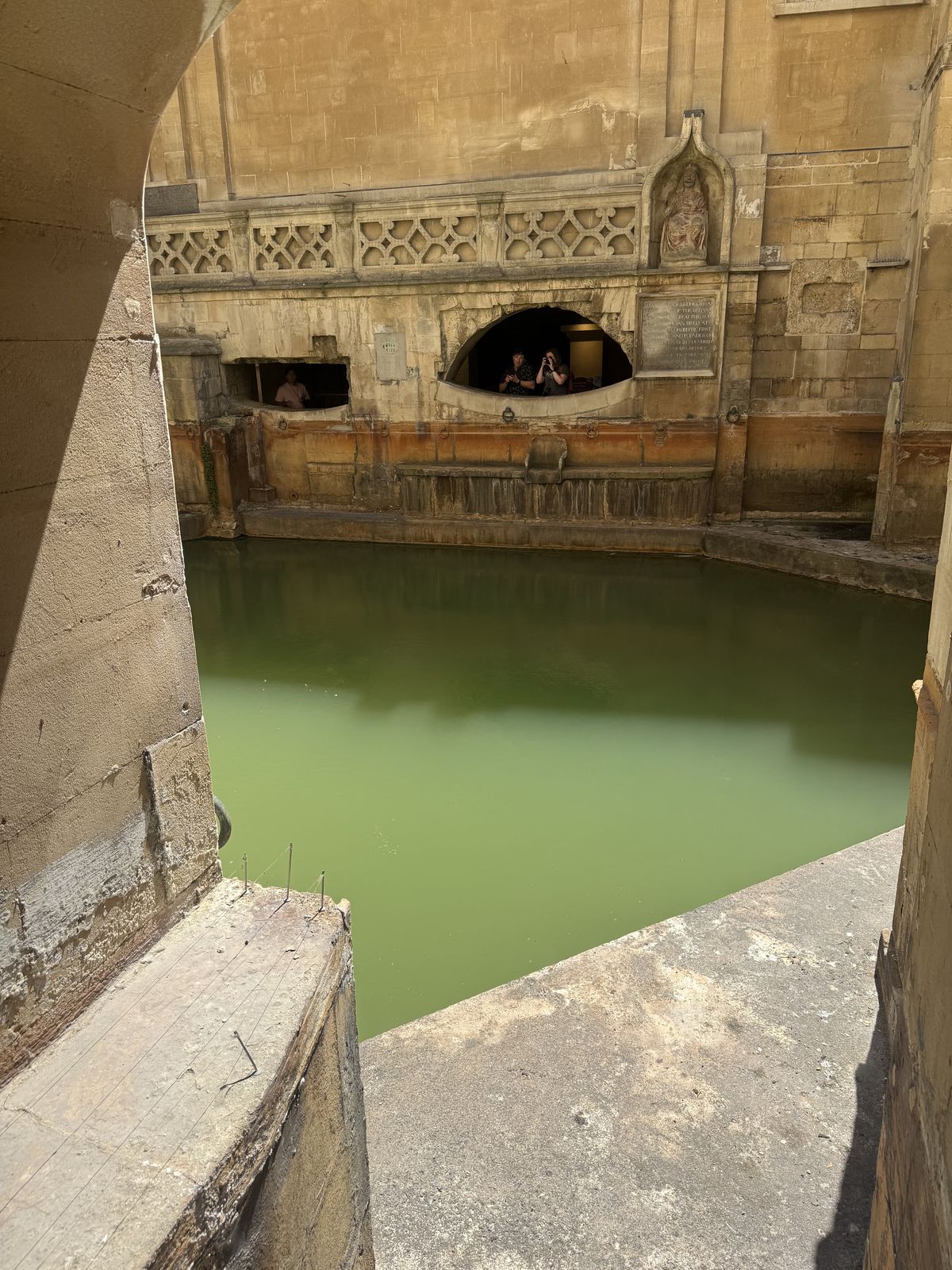 Steaming thermal water of the King's Bath spring at the Roman Baths