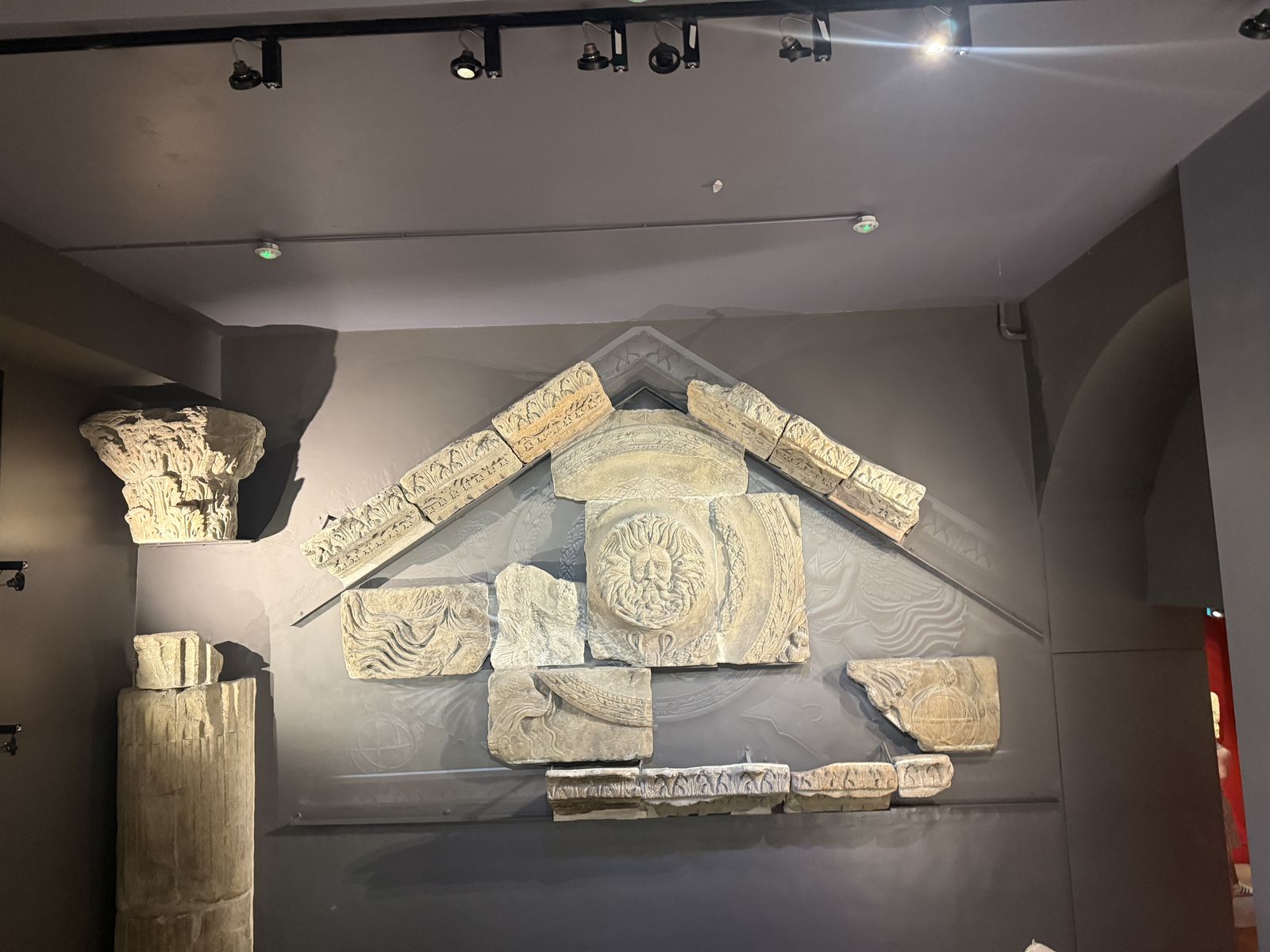 The reconstructed Temple pediment at the Roman Baths with the carved Gorgon's head at its centre